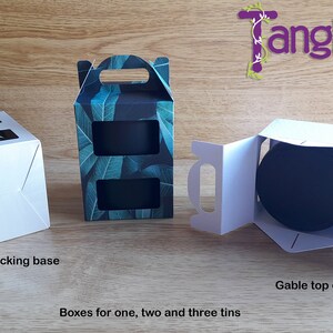 May include: Three white cardboard boxes with different designs for packaging one, two, or three tins. The boxes have a locking base and a gable top closure. The box on the left has a window to show the contents. The box in the middle has a leafy green pattern. The box on the right is open to show the inside.
