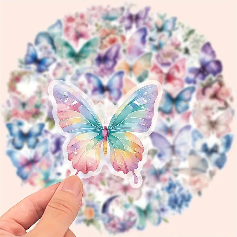May include: A collection of colorful butterfly stickers. The central sticker features a watercolor butterfly with a gradient of colors, including pink, yellow, blue, and green. Other stickers in the background are also butterflies and flowers.