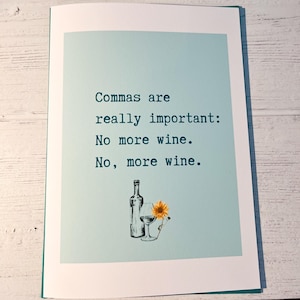 May include: Greeting card with a light blue background and the text "Commas are really important: No more wine. No, more wine." A wine bottle, glass, and sunflower are illustrated below the text.