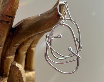 Unique design Sterling Silver dangle earrings.Free form silver wire with a twist.