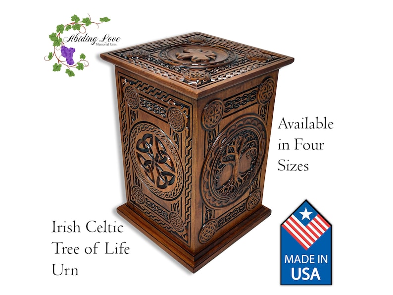 May include: A wooden urn with intricate Celtic knotwork and a tree of life design. The urn is available in four sizes and is made in the USA.