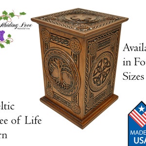 May include: A wooden Celtic Tree of Life urn with intricate carvings. The urn is available in four sizes and is made in the USA.  "Abiding Love Memorial Urns" is printed on the top left corner of the image.