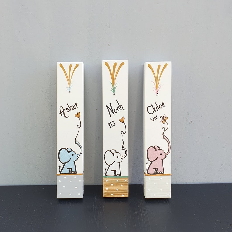 Hand painted elephant mezuzah case for nursery on white wood. Personalized Jewish mezuzah for baby room, kids room decor and meaningful newborn gift with custom name in Hebrew or English.