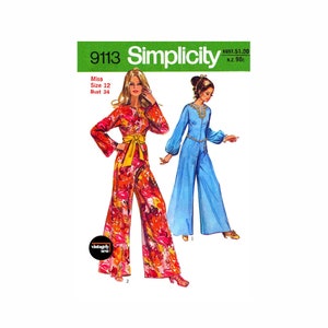 May include: Simplicity sewing pattern number 9113 for a jumpsuit. The pattern shows two women wearing different versions of the jumpsuit. One is wearing a floral print jumpsuit with a yellow belt and the other is wearing a solid blue jumpsuit. The pattern is for a miss size 12 with a bust of 86 cm.