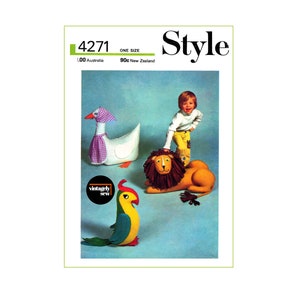 May include: A vintage sewing pattern for making stuffed animal toys. The pattern includes instructions for making a goose, a lion, and a parrot. The pattern is from the 1970s and features a blue background with a child playing with the finished toys.