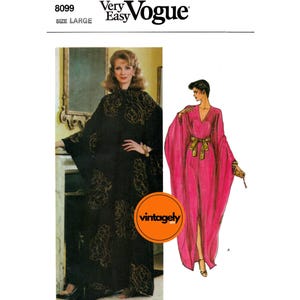 May include: Vintage Vogue sewing pattern showing two caftan designs. One is black with gold floral detailing, the other is a bright pink with a gold belt. The pattern is size large.