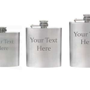 May include: Three stainless steel hip flasks in different sizes, each with a screw cap and a hinged arm. The flasks have a brushed metal finish and the text "Your Text Here" is engraved on the front.