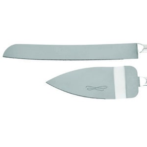 May include: A silver cake knife set with a serrated blade and a smooth, rounded spatula. The spatula has a decorative design.