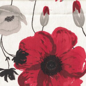 May include: A white fabric with a red and gray floral pattern. The flowers are stylized and have a painterly look. The background is white.