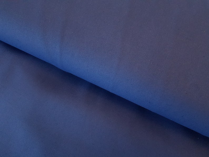 May include: A close-up of a dark blue fabric with a smooth texture.