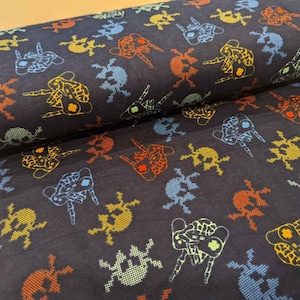 May include: Black fabric with a repeating pattern of colorful pixelated skull designs. The skulls are in various colors, including blue, green, yellow, and orange.