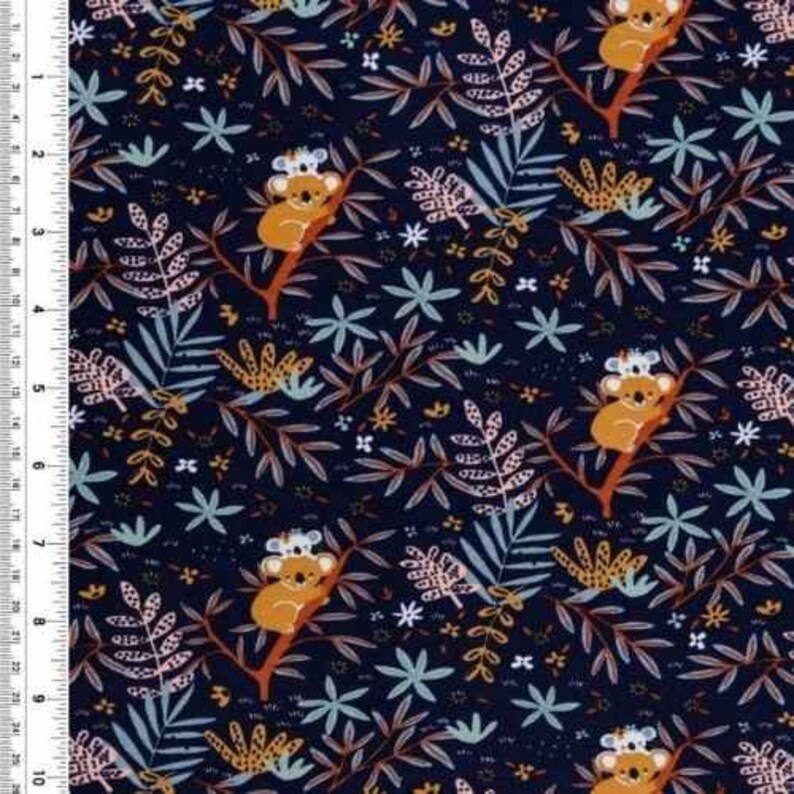 May include: A dark blue fabric with a repeating pattern of koalas, leaves, and flowers. The koalas are brown and white and are holding onto branches. The leaves are green and yellow, and the flowers are pink and white.