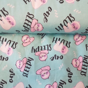 May include: A turquoise fabric with a repeating pattern of pink cartoon sloths and the text "one sleepy sloth".