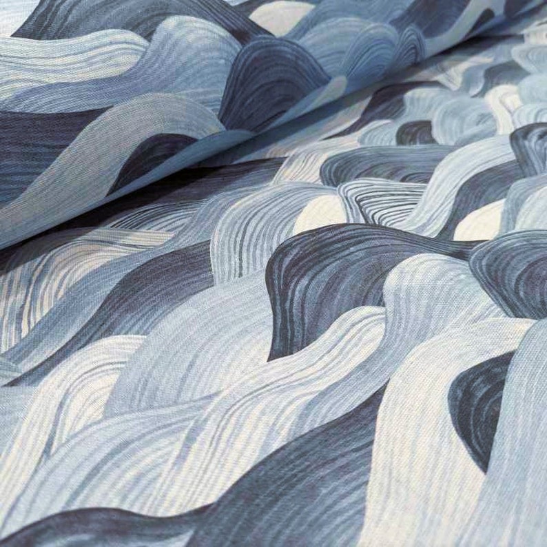 May include: A fabric with a repeating wave pattern in shades of blue and white. The design features flowing, curved lines that create a sense of movement and depth. The fabric appears to be a woven material.
