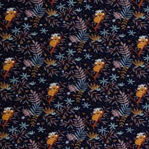 May include: A dark blue fabric with a repeating pattern of koalas sitting in trees. The trees are stylized and have brown branches and green leaves. The koalas are brown with white ears and noses. The background is a dark blue with small white stars and other floral details.