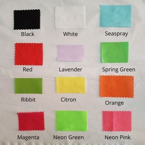 May include: Swatch card with 12 fabric samples in various colors, including black, white, red, lavender, green, yellow, orange, magenta, and neon green. The fabric samples are labeled with their corresponding color names.