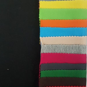 May include: A variety of fabric swatches in different colors, including white, light blue, pink, orange, green, gray, yellow, lime green, blue, beige, red, dark green, brown, red, blue, purple, and black.