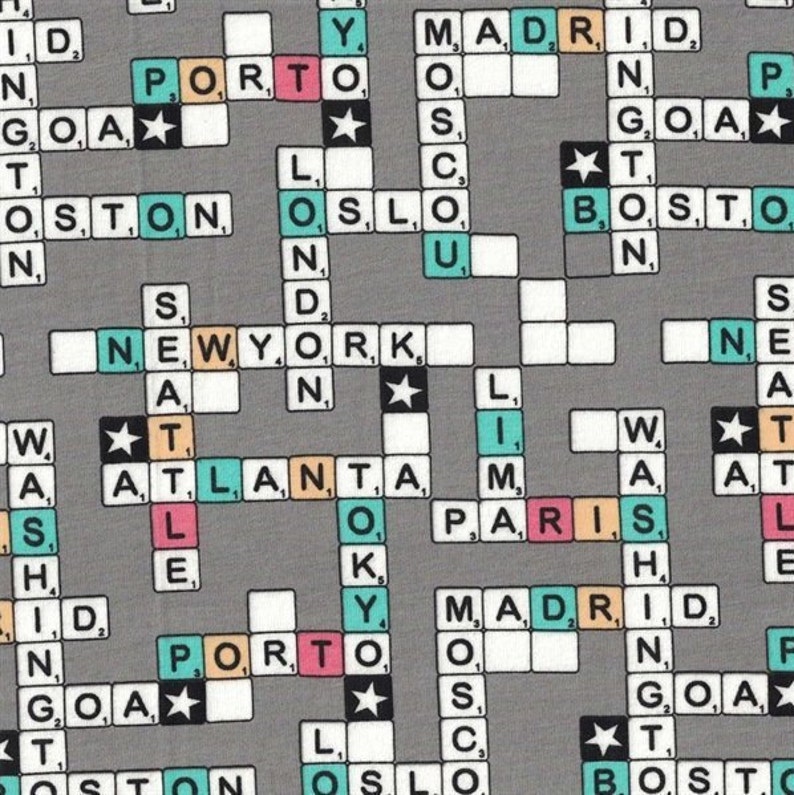 May include: Gray fabric with a repeating pattern of crossword puzzle tiles. The tiles spell out city names like New York, Boston, and Paris, with star accents. The letters and numbers are in various colors.
