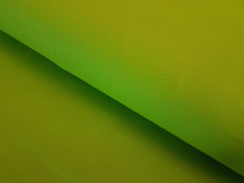 May include: A close-up of a green fabric with a gradient from a darker green to a lighter green.