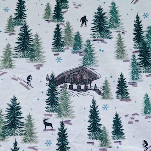 May include: A white fabric with a winter scene print. The design features evergreen trees, a cabin, skiers, a deer, a sasquatch, and snowflakes. The color palette includes shades of green, brown, and blue.