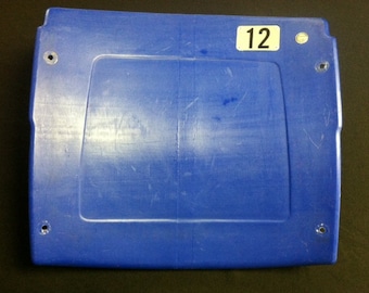 Op de afbeelding: Een blauwe plastic stadionstoel met het nummer "12" erop.
