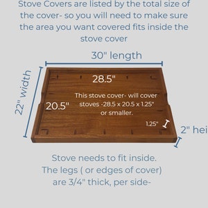May include: A wooden stove cover measuring 28.5 inches by 20.5 inches by 1.25 inches. The cover is made of natural wood and has a light brown colour. The text on the cover reads: "This stove cover - will cover stoves - 28.5 x 20.5 x 1.25" or smaller."