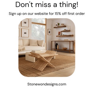 May include: A light brown wooden folding table with a woven rug underneath. The table is in a living room with a white couch and a wooden shelf unit with decorative items.