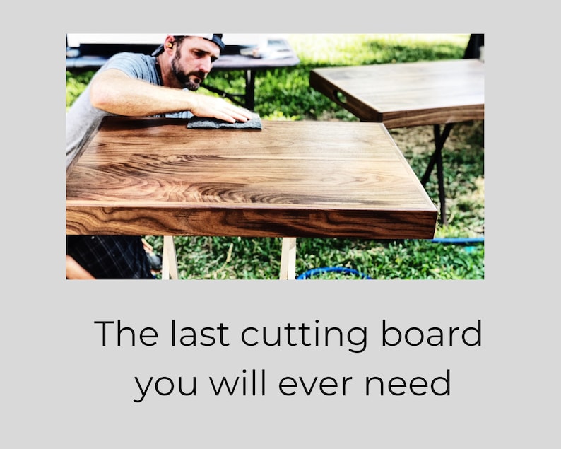 May include: A close-up of a large, wooden chopping board being finished with a sanding block. The board has a rich brown colour and a beautiful grain pattern. The board is sitting on a wooden stand.