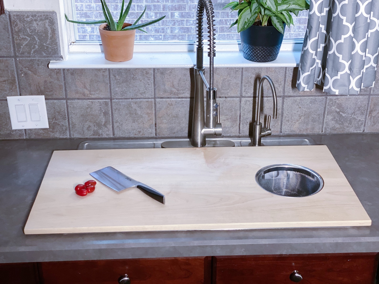stainless kitchen sink with cutting board