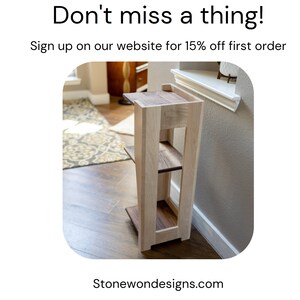 May include: A wooden shelf unit with three shelves. The shelves are made of light wood with a darker wood trim. The unit is standing in a room with hardwood floors.