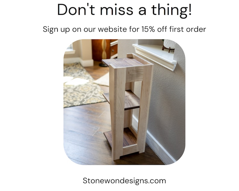 May include: A wooden shelf unit with three shelves. The shelves are made of light wood with a darker wood trim. The unit is standing in a room with hardwood floors.