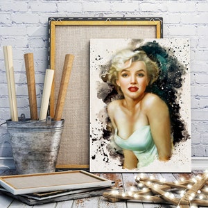 May include: A canvas print of Marilyn Monroe in a watercolor style, with a light green dress and red lipstick. The artwork is displayed with other art supplies and a wooden frame, creating a vintage aesthetic.