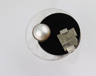 Silver avant-garde brooch with quartz, onyx, pearl and pyrite