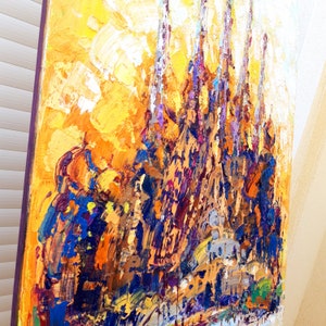 May include: Abstract oil painting of a cityscape with tall buildings in shades of yellow, orange, purple, and blue.