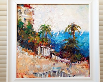 May include: A framed oil painting depicting a coastal scene with palm trees, a white building, and sailboats on a blue ocean. The painting has a textured brushstroke style and a warm colour palette.