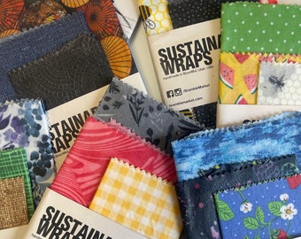 May include: A close-up of a variety of colorful reusable food wraps with a bee design. The wraps are made of beeswax, jojoba oil, and tree resin. The text on the label reads "Sustainable Wraps" and "handmade in Bountiful, Utah, USA".