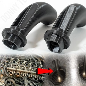 May include: Two black plastic engine valve covers with a curved handle. The covers are designed to fit over the engine valves and help to prevent dirt and debris from entering the engine.