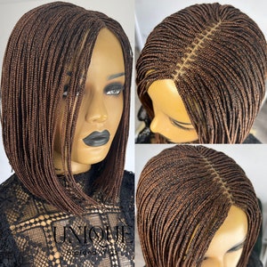 May include: A brown and black braided wig with a bob style. The wig is made with small, thin braids and has a lace front.