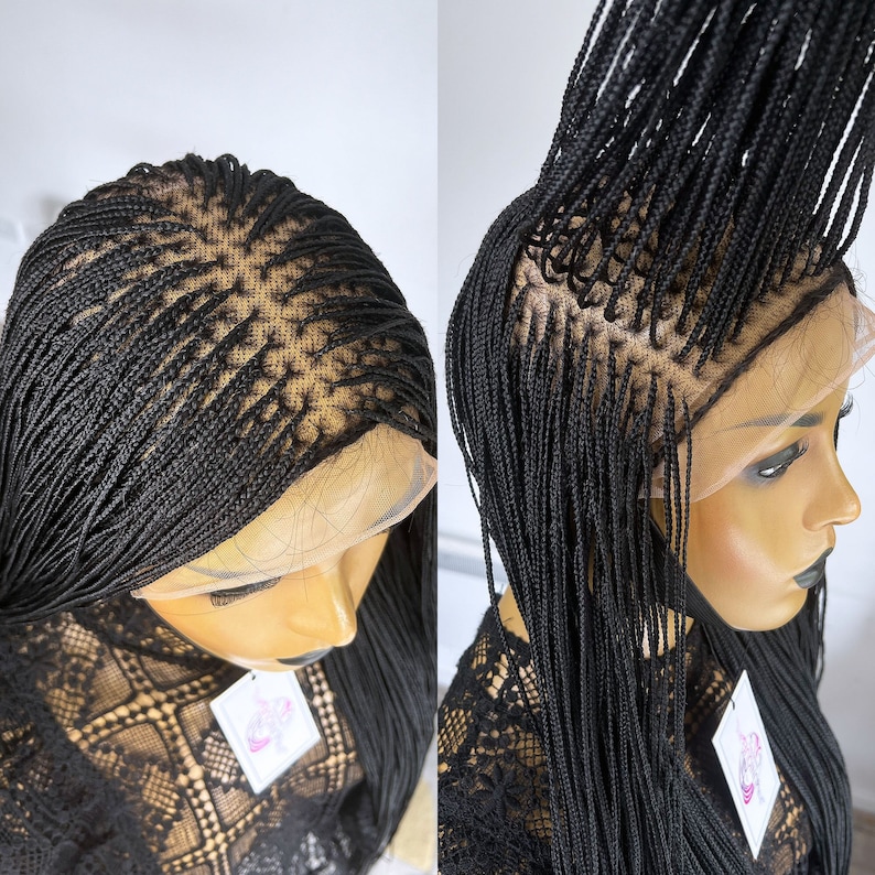 May include: Black braided wig with a lace front. The wig is styled in small braids and is long and straight.