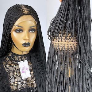 May include: Black braided wig with a lace front. The wig is styled in small, thin braids that are long and straight. The wig is on a mannequin head.