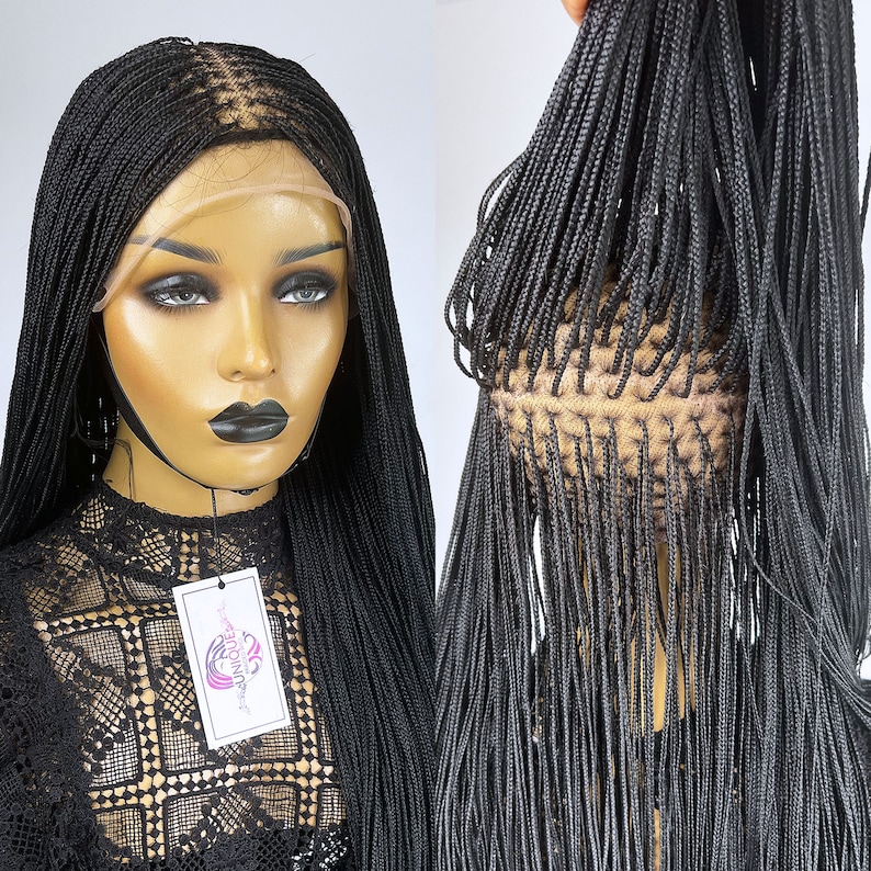 May include: Black braided wig with a lace front. The wig is styled in small, thin braids that are long and straight. The wig is on a mannequin head.