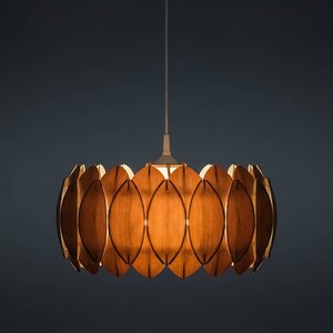 May include: A wooden pendant light fixture with a circular design. The fixture is made up of multiple overlapping wooden leaves, creating a unique and modern look.