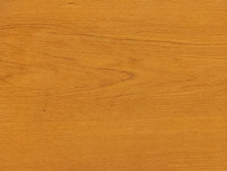 May include: A flat, rectangular surface featuring a warm, golden-brown wood grain pattern. The texture displays horizontal lines and natural organic swirls characteristic of polished timber, creating a consistent and smooth appearance throughout.