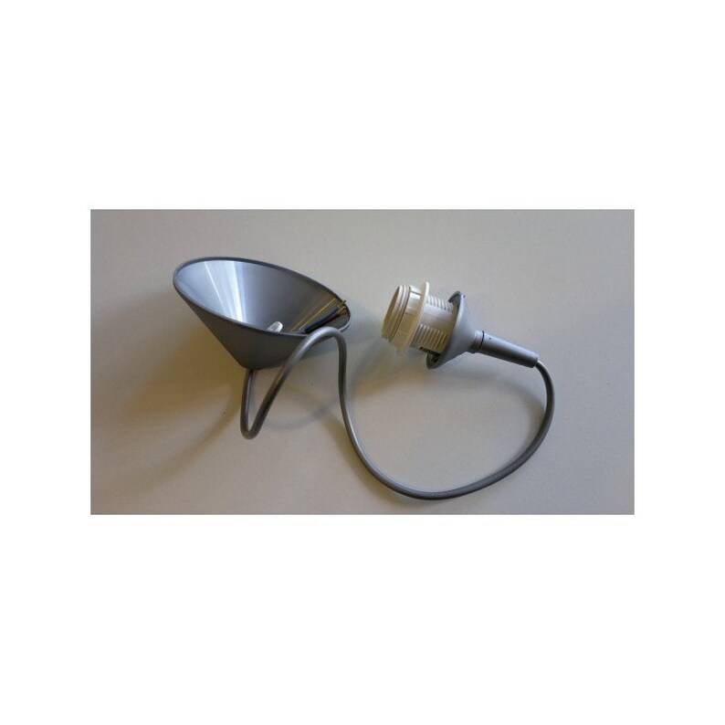 May include: A grey metal pendant light fitting with a cone-shaped shade and a curved support arm. The fitting includes a light socket and a grey electrical cable. The design is minimalist and modern.