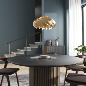 May include: A pendant light fixture featuring a spiraling, layered shade made of light-colored wood strips. The fixture hangs from a thin black cord and is positioned above a round, dark gray dining table with a fluted, cylindrical wooden base.