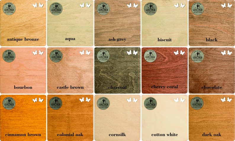 May include: A display of wooden squares stained in a range of colours: antique bronze, aqua, ash grey, biscuit, black, bourbon, castle brown, charcoal, cherry coral, chocolate, cinnamon brown, colonial oak, cornsilk, cotton white, and dark oak.