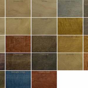 May include: A wood stain color chart with 25 different wood stain colors. The colors are arranged in a grid of five rows and five columns. The colors include Smoke, Smoke 5%, White, Silver Grey, Havanna, White 5%, Mist 5%, Cornsilk, Olive, Slate Grey, Super White, Mahogany, Black, Antique Bronze, Colonial Oak, Heather Purple, Chocolate, Charcoal, Invisible, Ice Brown, Savanna, Midnight Indigo, and Cherry Coal.