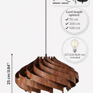 May include: Wooden pendant light fixture with a swirling design. The fixture is 17.71 inches wide, 9.84 inches tall, and includes all ceiling mounting hardware. Cord length options are 27.56 inches, 78.74 inches, and 196.85 inches. E27/E26 bulb not included.