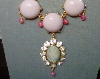 Pale lavender necklace with pink accents and oval pendant with green and pink color
