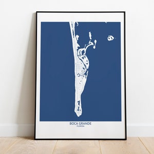 May include: A framed print of a map of Boca Grande, Florida. The map is white on a dark blue background. The text "Boca Grande, Florida" is printed at the bottom of the map.